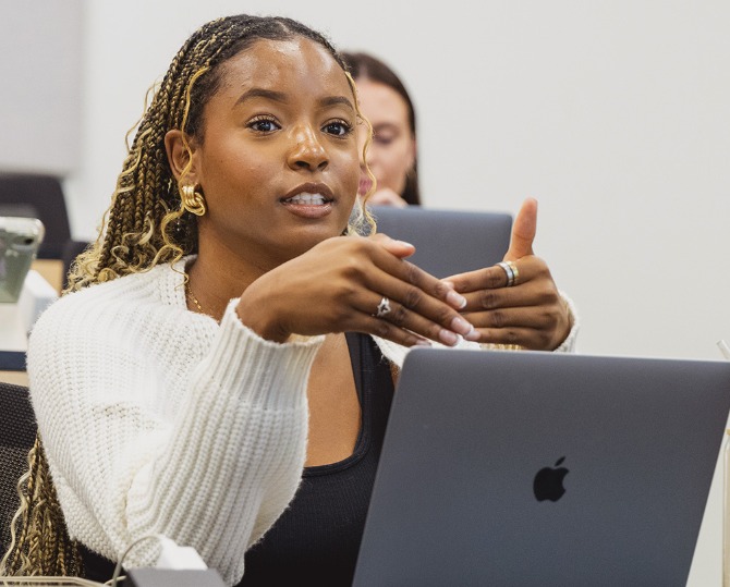 A graduate student making a point during a lecture.