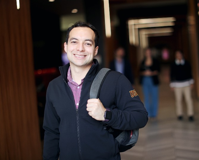 male student smiling in a hallway