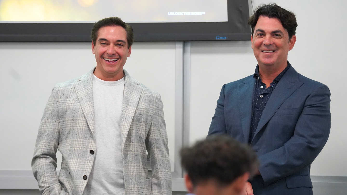 Chad Tons and Miles Rogers smiling in front of the class.