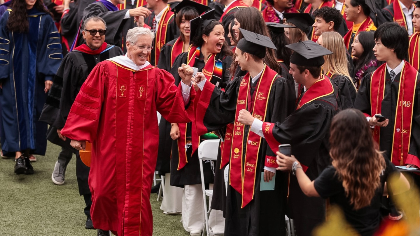 Pete Carroll walking down the aisle at commencement