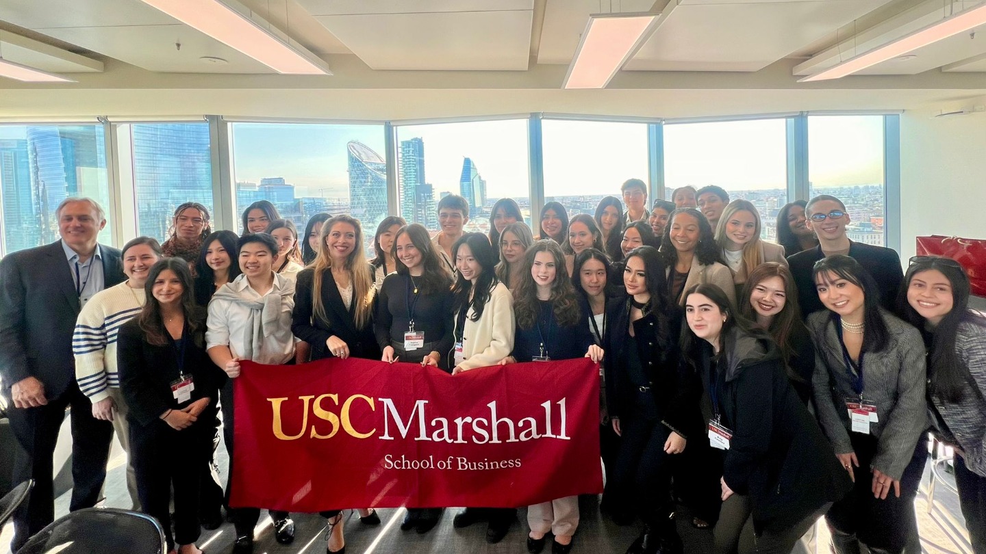 Students holding up the USC Marshall banner in Italy