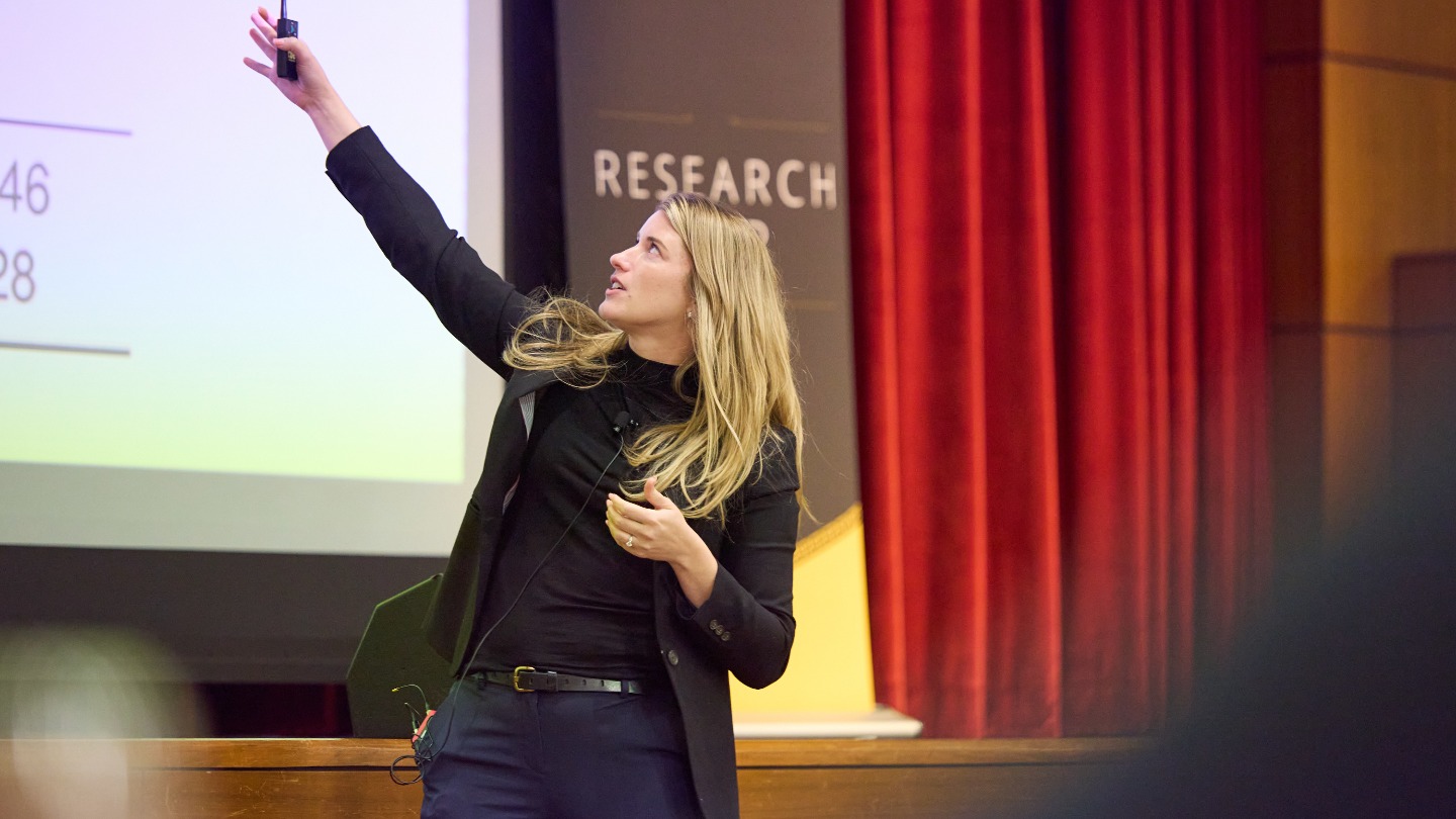 Emily Nix gestures to the screen.