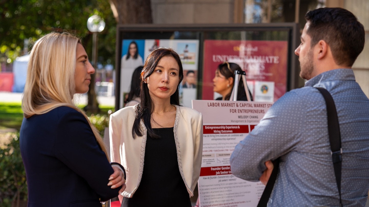 Assistant Professors Andrea Dittman and Melody Chang discuss their presentations with Associate Professor Eric Anicich during the Assistant Professor Research Day.