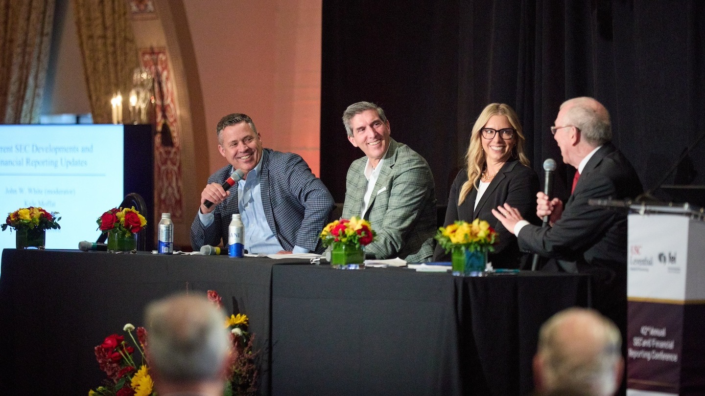 Financial reporting experts speak during a panel discussion.