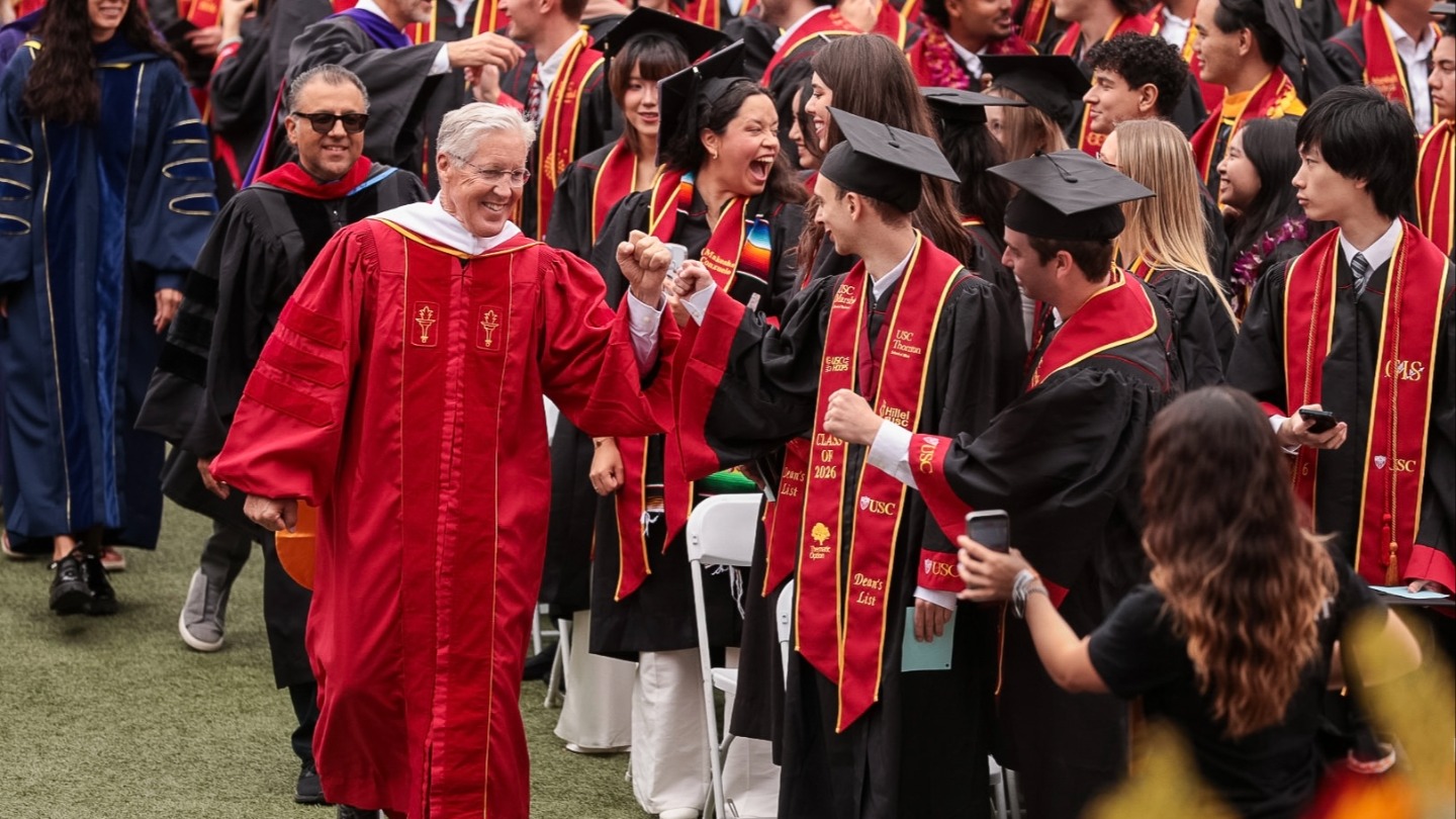 Pete Carroll walking down the aisle at Commencement