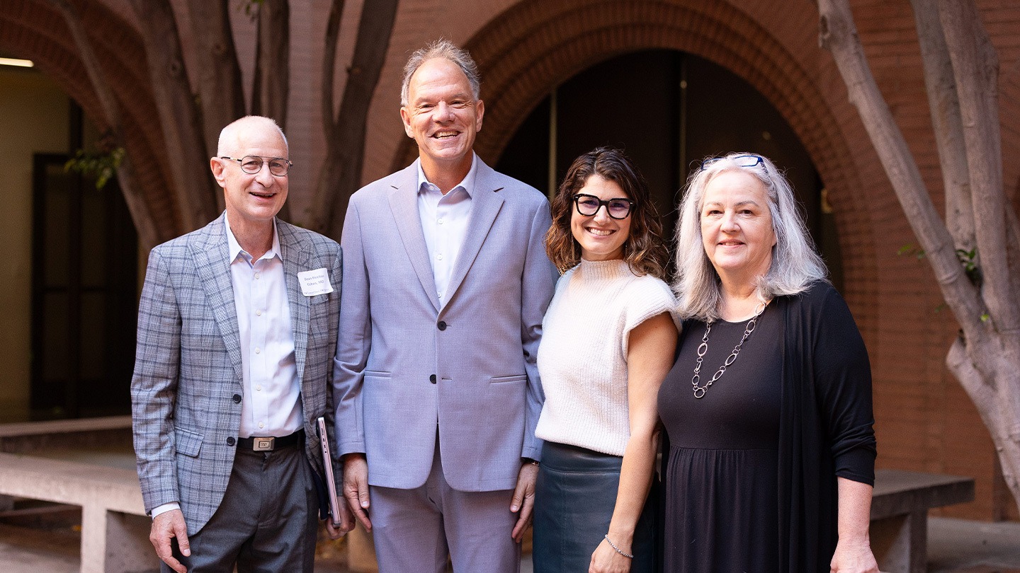 Color photograph of Leonard Davis School Dean Pinchas Cohen, USC Marshall Dean Geoffrey Garrett, Abby Fifer Mandell, and Maria Henke.