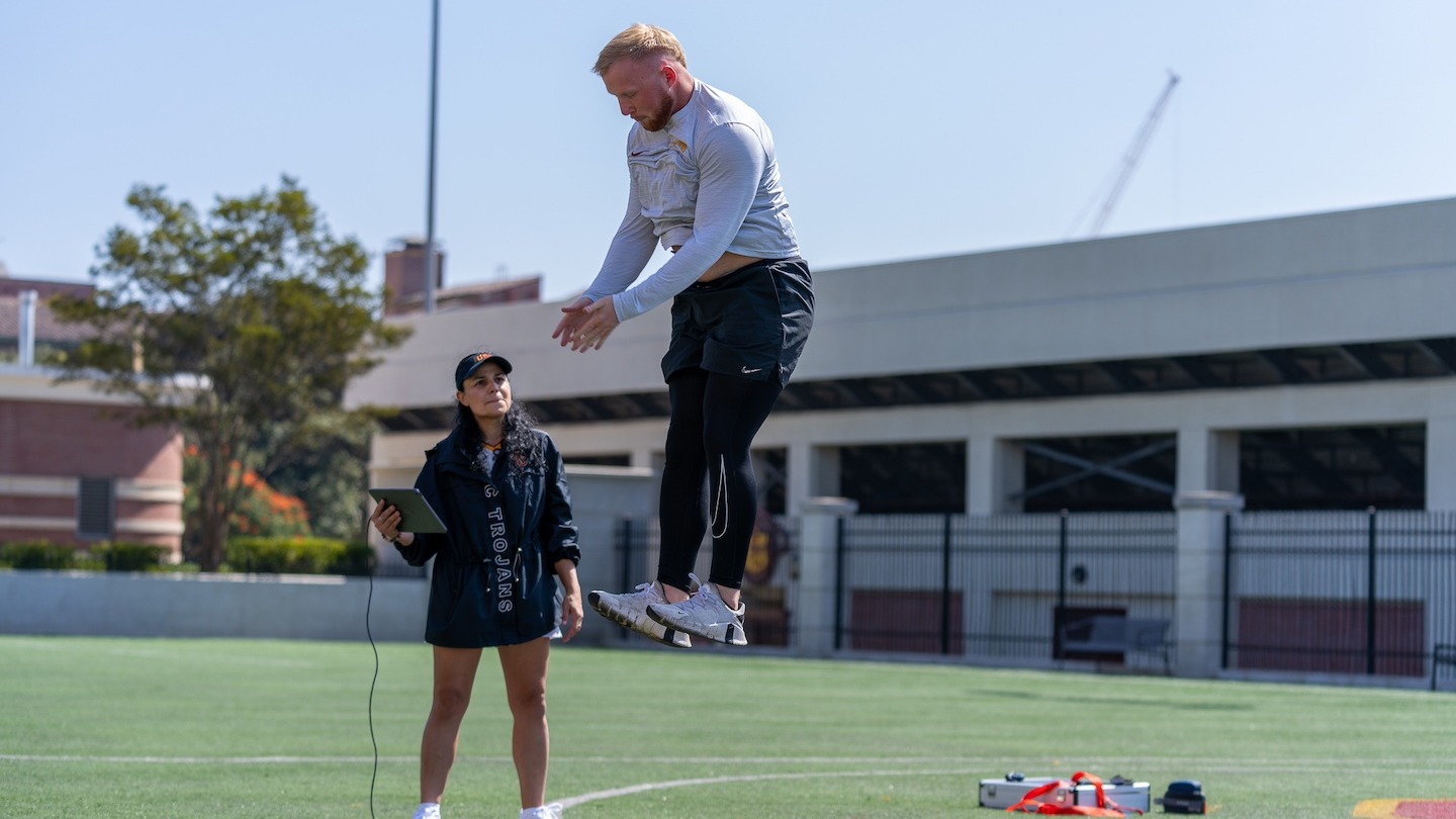 Professor Lorena Martin guides student Nick Adgar in a sports assessment test