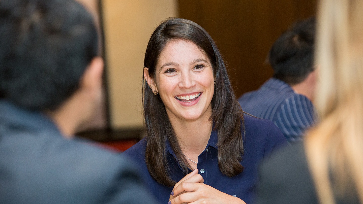 Female-presenting student smiling.