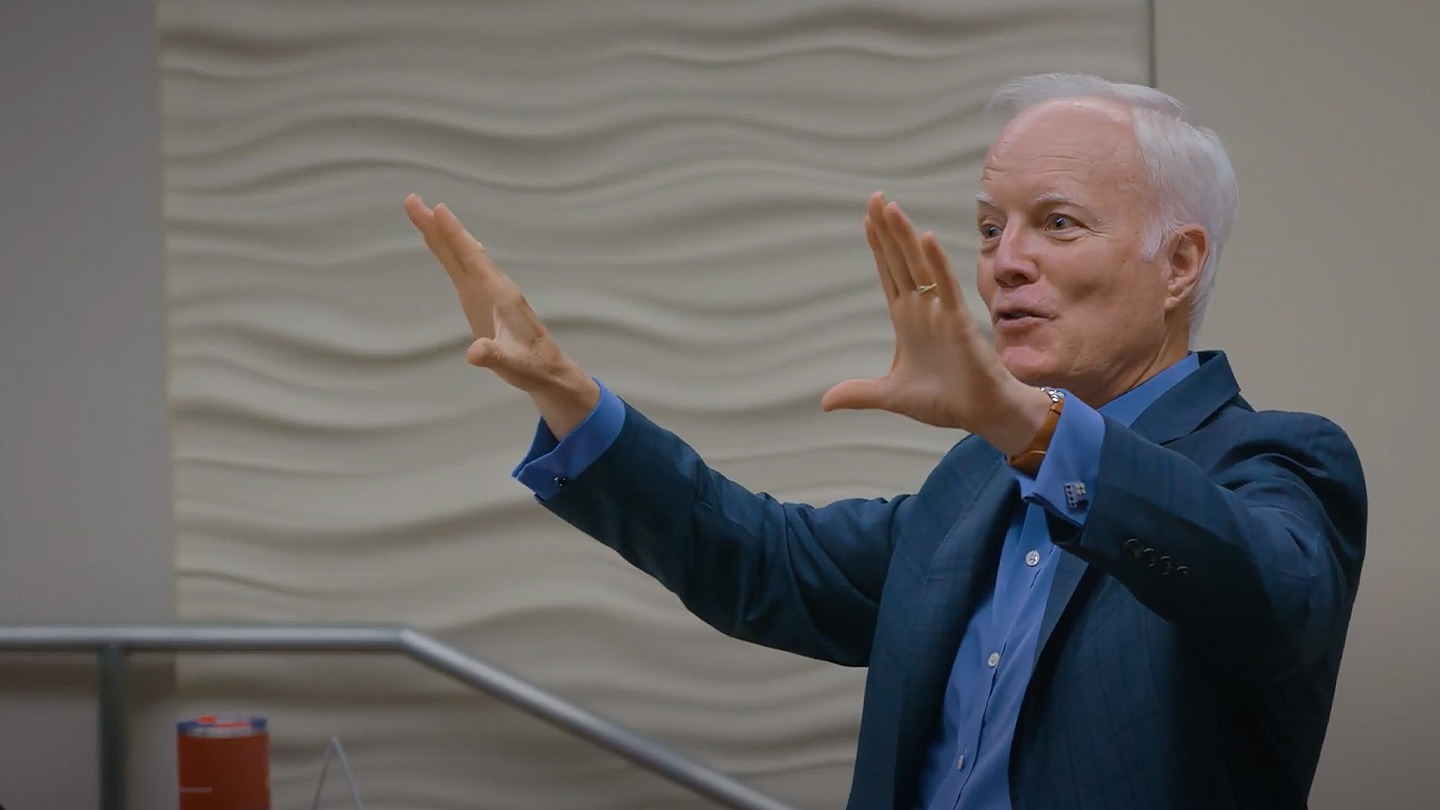 Color photograph of a male-presenting professor leading a lecture at the USC Marshall School of Business.