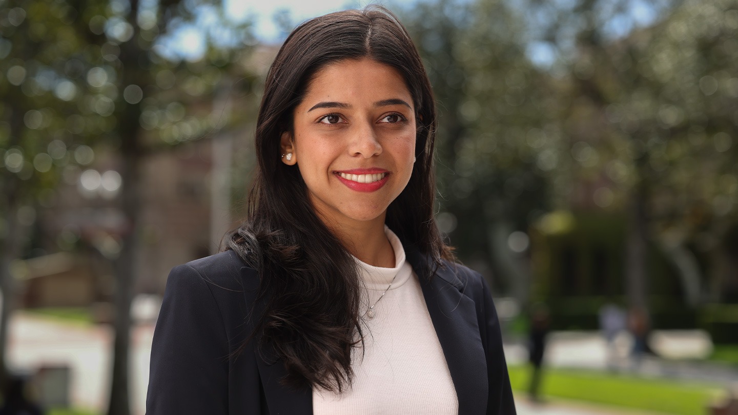 Color photograph of a USC Marshall student on campus in the day.
