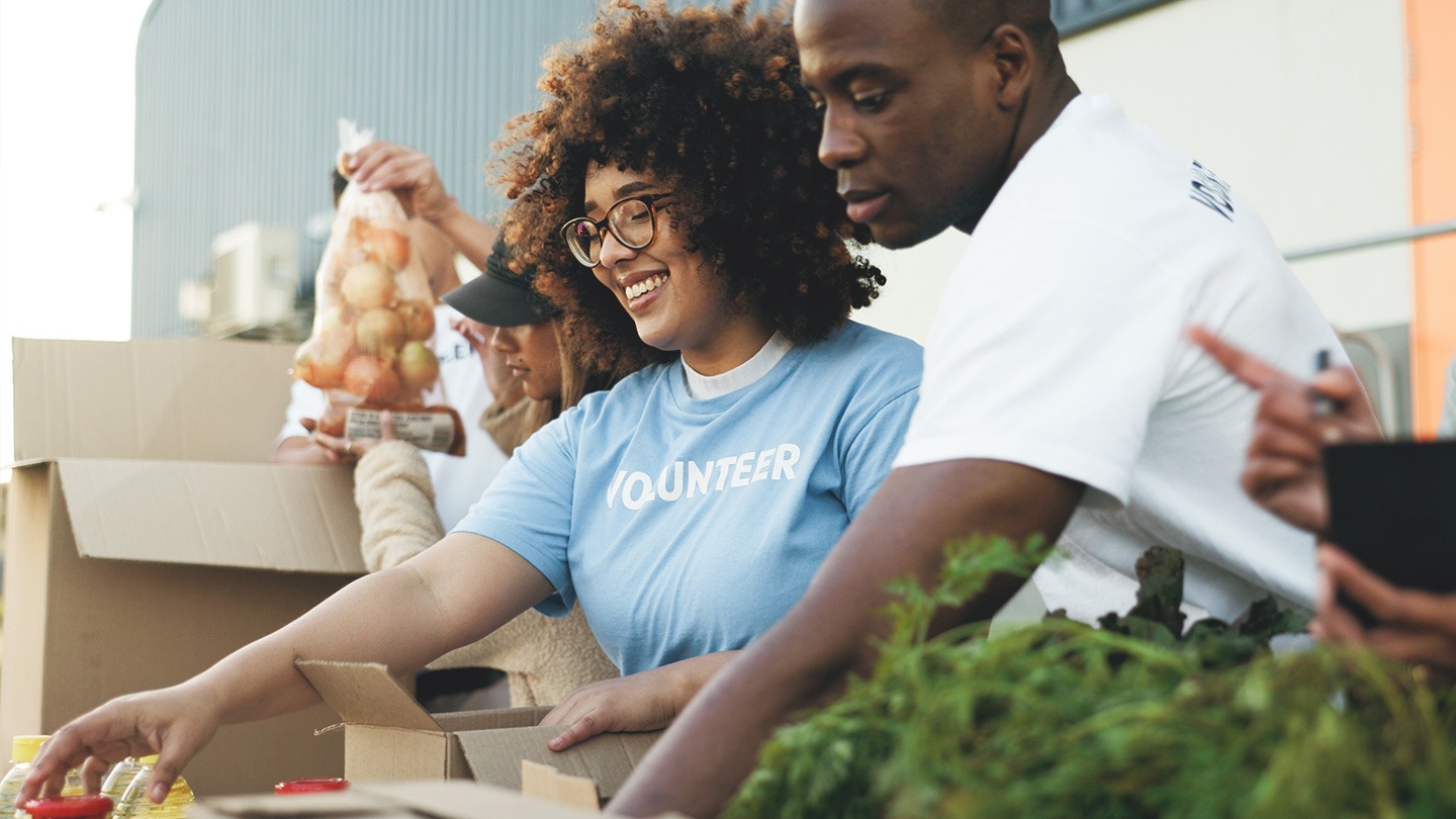 Volunteers filling boxes of food.