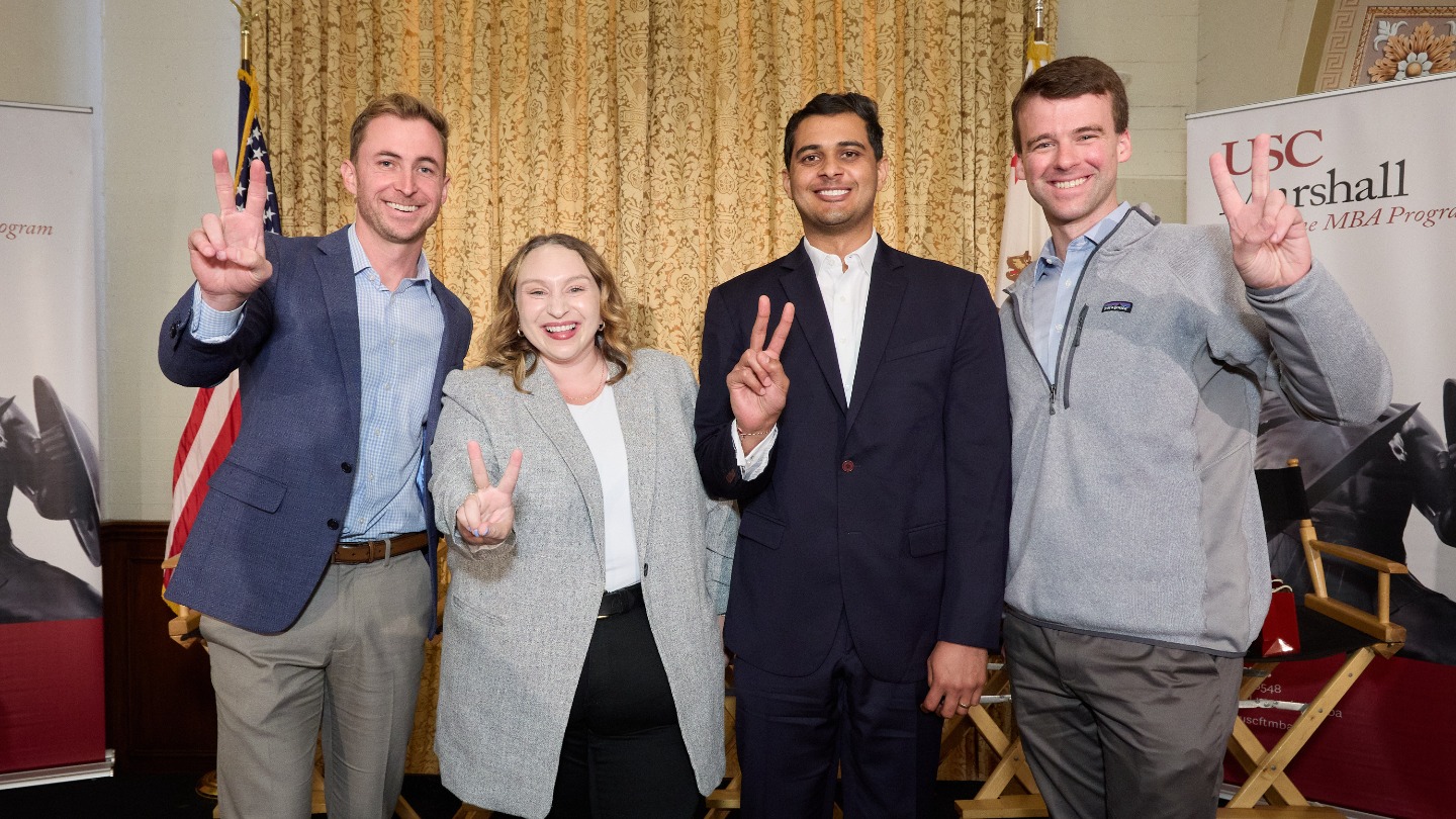 MBA alumni giving the Fight On sign