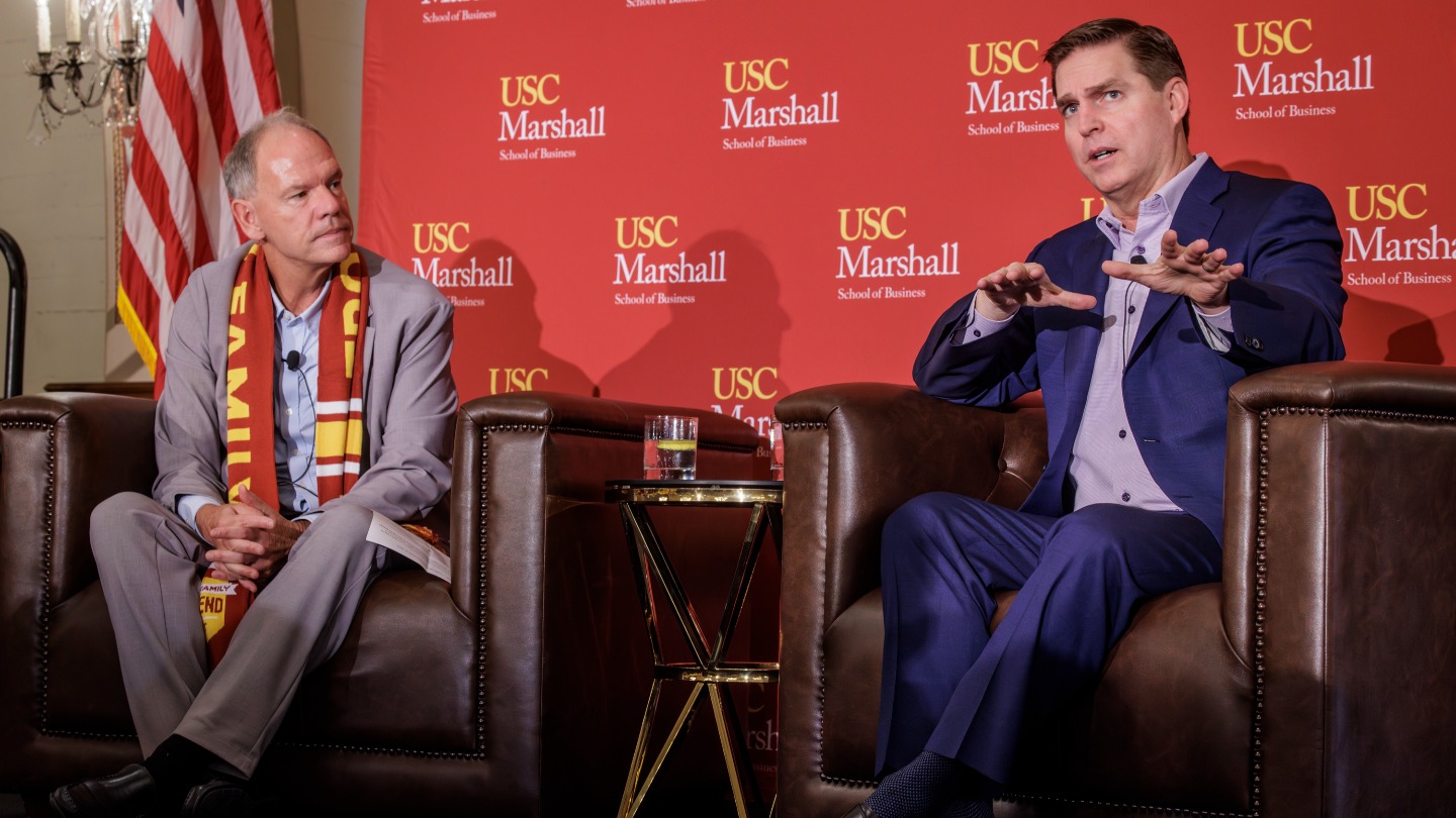 Bret Johnsen speaking with Dean Geoff Garrett