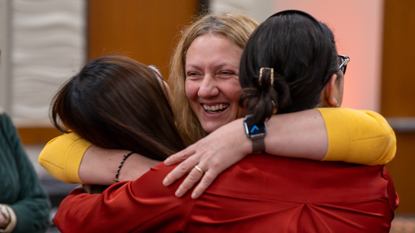 Rahsan Akbulut hugging two colleagues