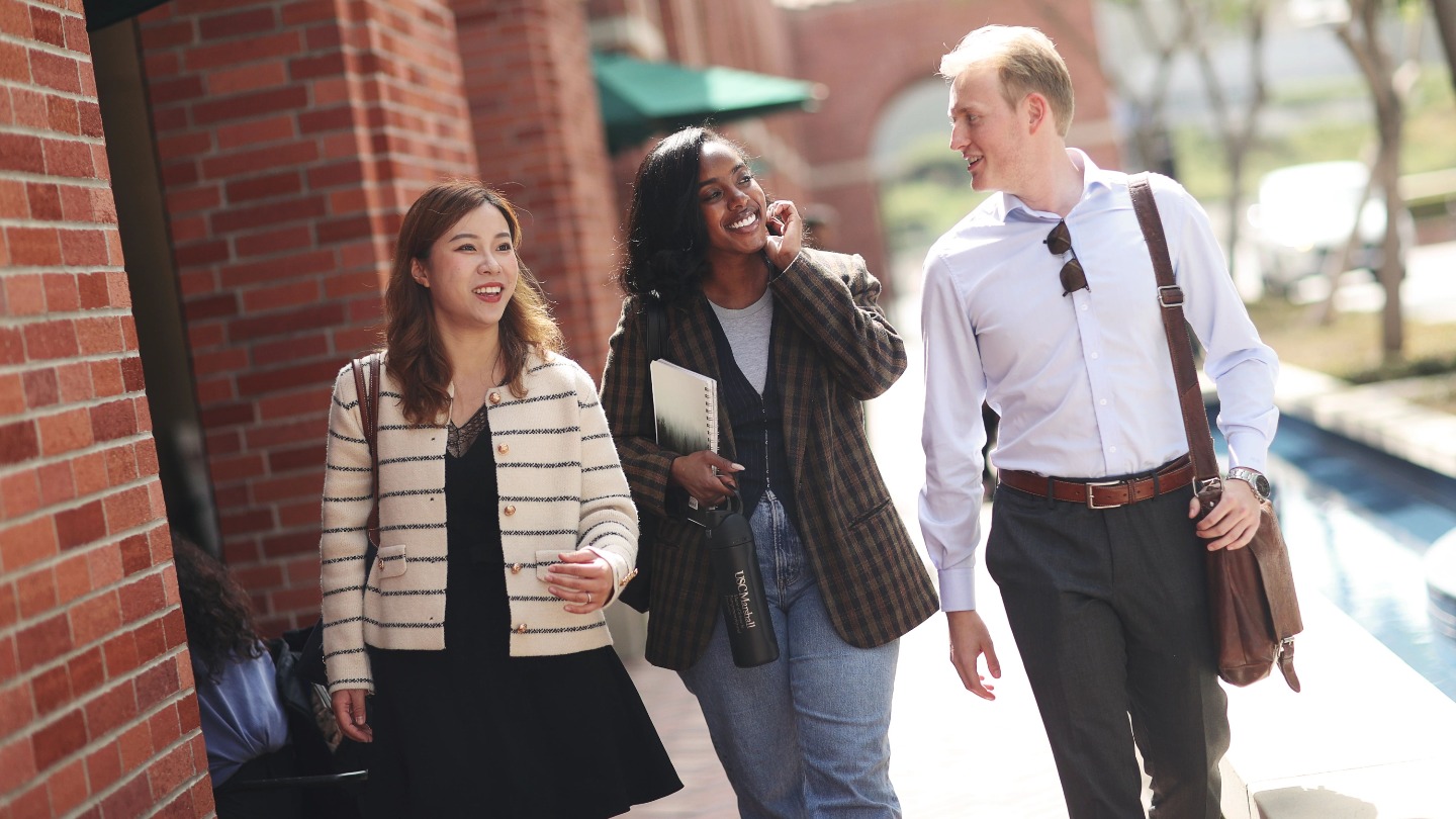 three Marshall students walking through campus