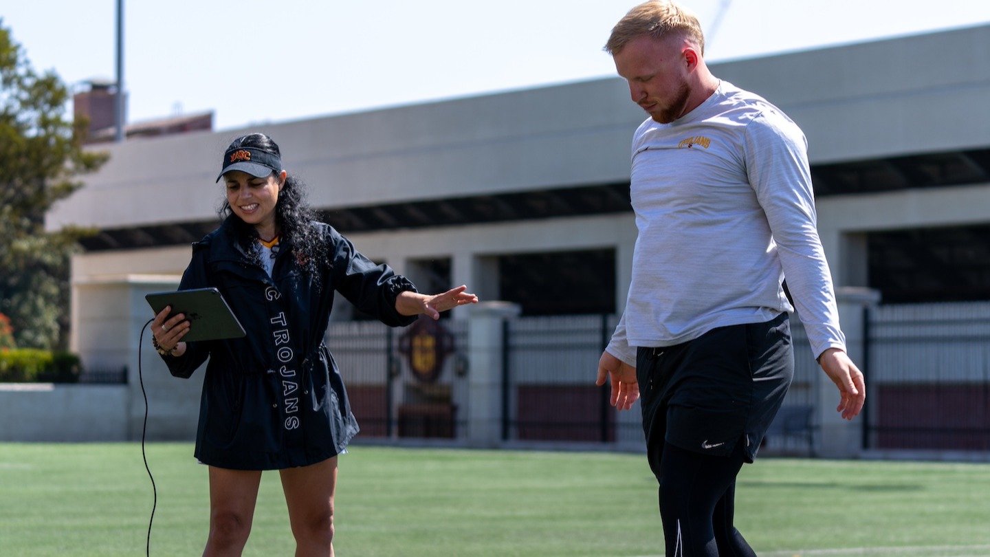 Professor Lorena Martin guides student in sport performance analytics