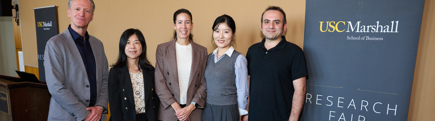 USC Marshall professors standing next to each other posing for a photo