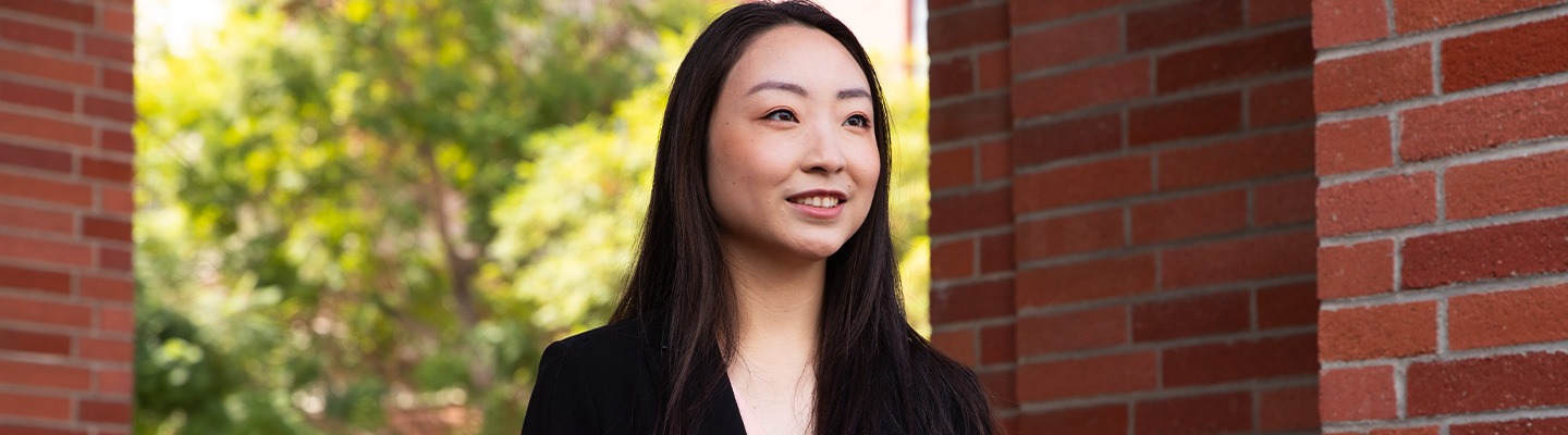 A female-presenting graduate student on the campus of USC.