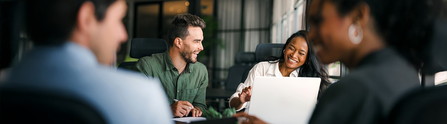 Two graduate students enjoying a laugh during a meeting.