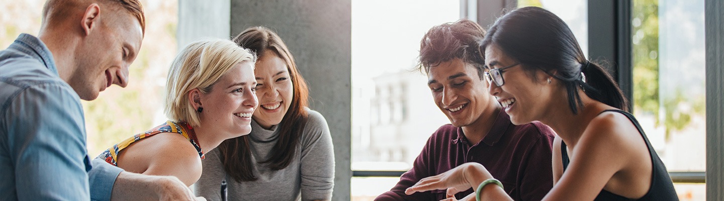 Five students working together indoors.