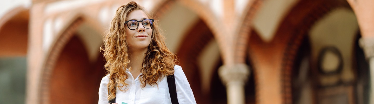 A female-presenting student outdoors.