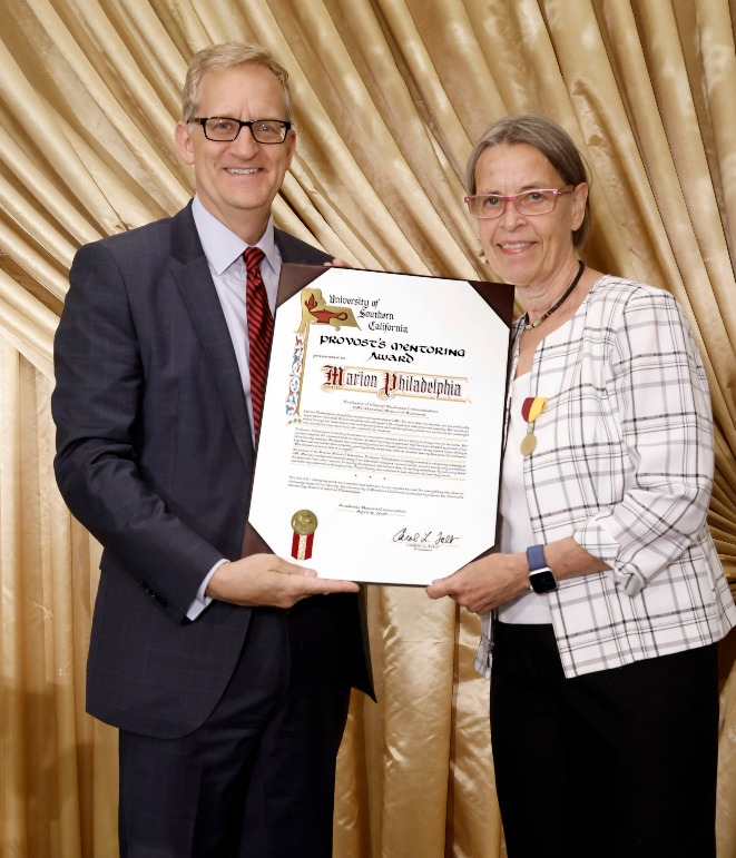 Andrew Guzman presenting Marion Philadelphia with her award.