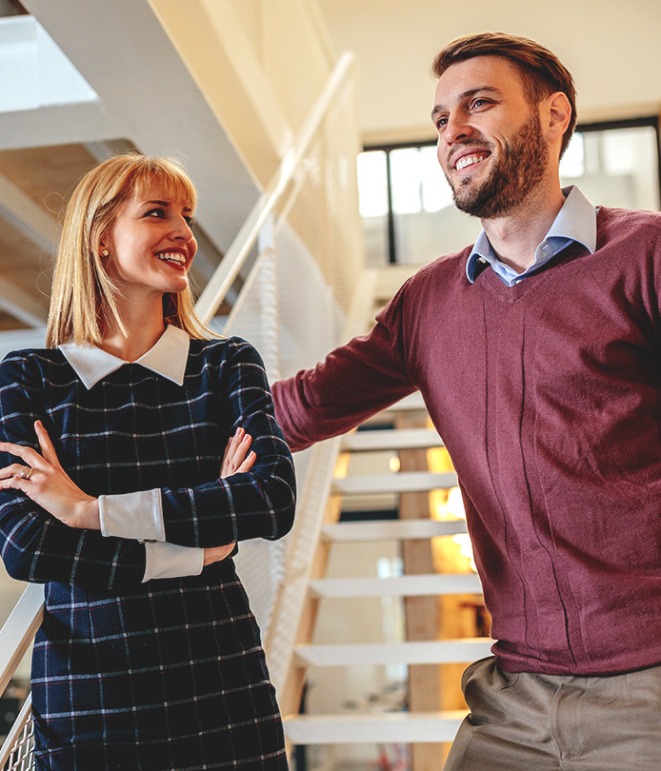 Two young professional colleagues in an office setting.