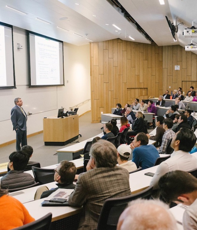 Color photograph of a professor visiting USC Marshall holding a lecture.
