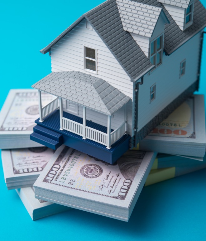 decorative image of a house on stacks of cash
