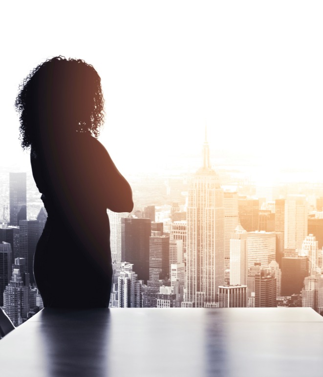 decorative image of person looking at city through window