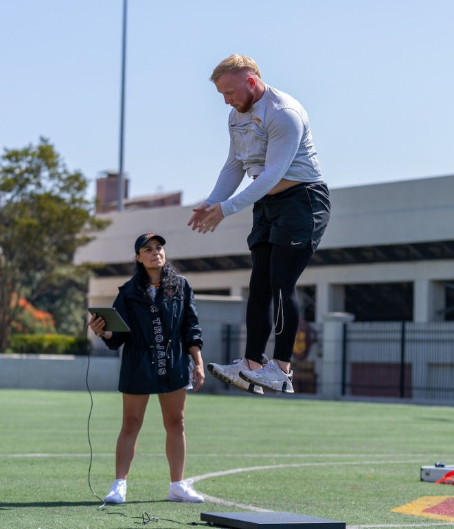 Professor Lorena Martin guides student Nick Adgar in a sports assessment test
