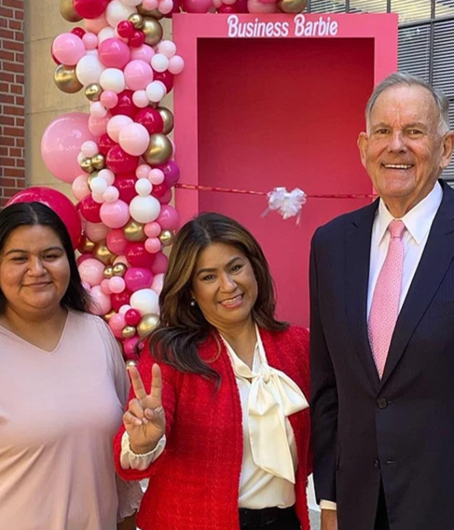 Kimberly Carbajal, Maria Romero-Morales, and Bill Holder give the Fight On sign in front of the Barbie box