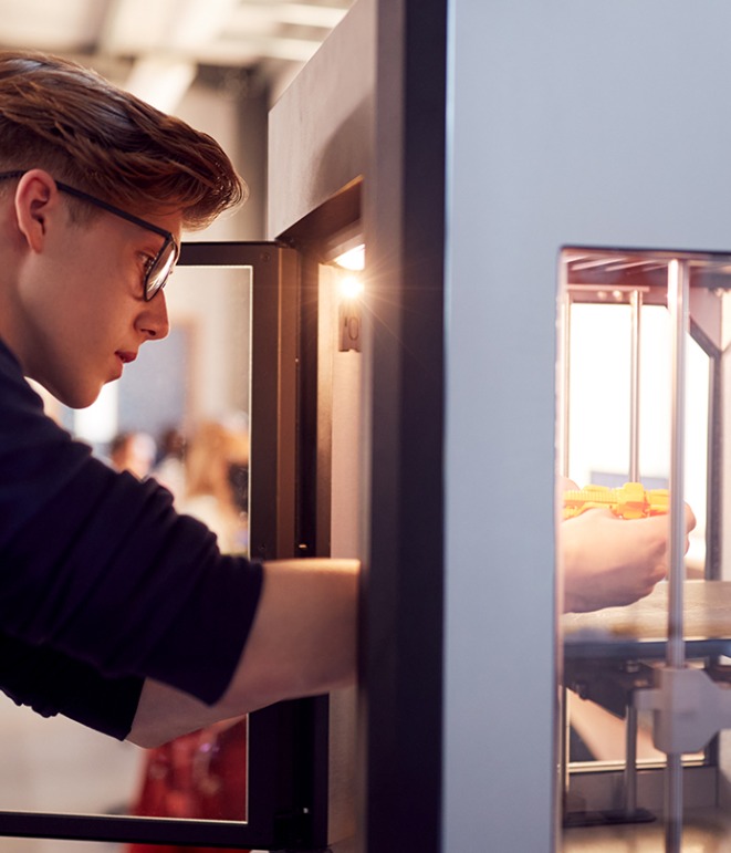 Male College Student Studying Engineering Using 3D Printing Machine.