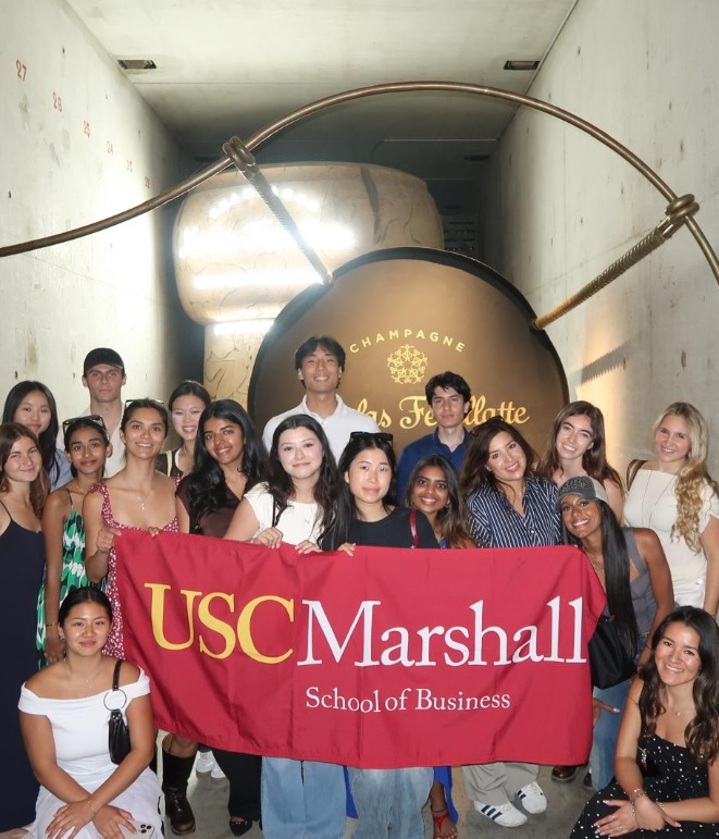 ExCEL students posing with the Marshall flag at nicolas feuillatte