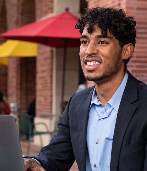 Student with computer outside