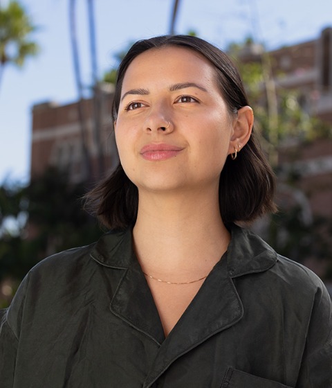 Color photograph of a student on the campus of USC during a sunny day.