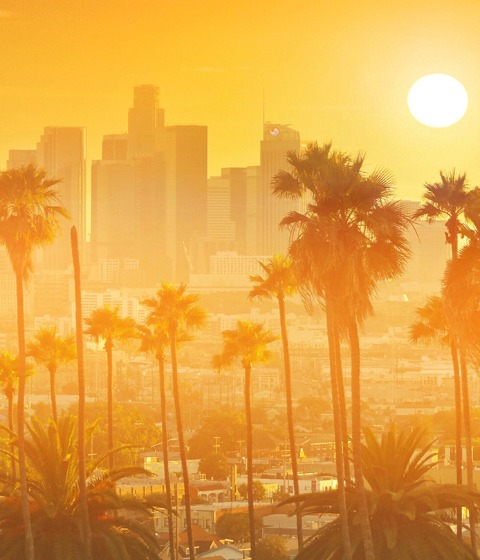Color photograph of the Los Angeles skyline at sunset.