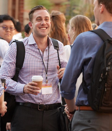 Color photograph of a group of USC Marshall students at an afternoon mixer.
