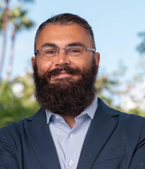 Color photograph of assistant professor of management and organization Joe Raffiee on the USC campus.