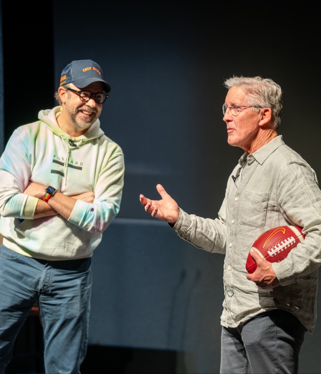 Jason Sudeikis and Pete Carroll in class