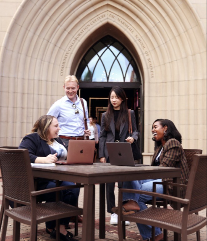 Students working at a table outdoors