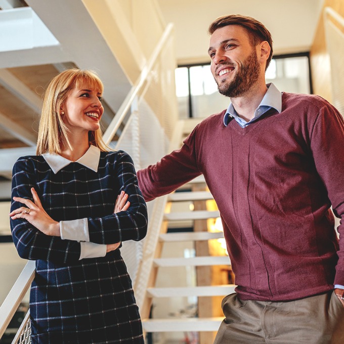 Two young professional colleagues in an office setting.