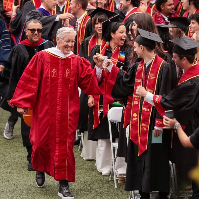 Pete Carroll walking down the aisle at Commencement