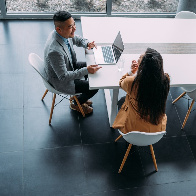 decorative image of a man and woman in the workplace.
