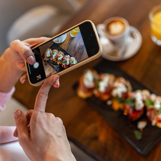 an influencer taking photos of food