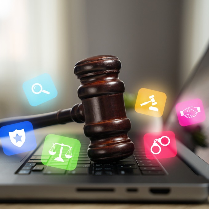 a gavel on a keyboard surrounded by social media icons