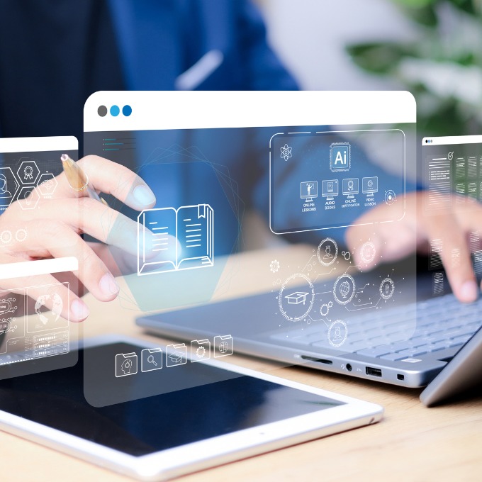 hands typing on a computer with digital screens in front