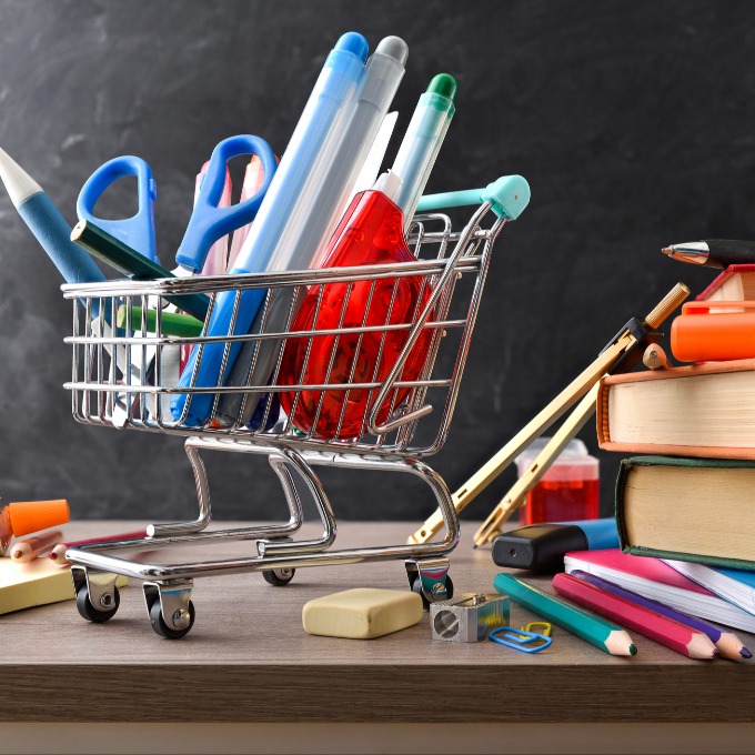 school supplies in a small shopping cart