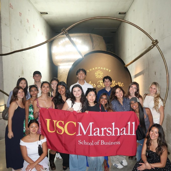 ExCEL students posing with the Marshall flag at nicolas feuillatte