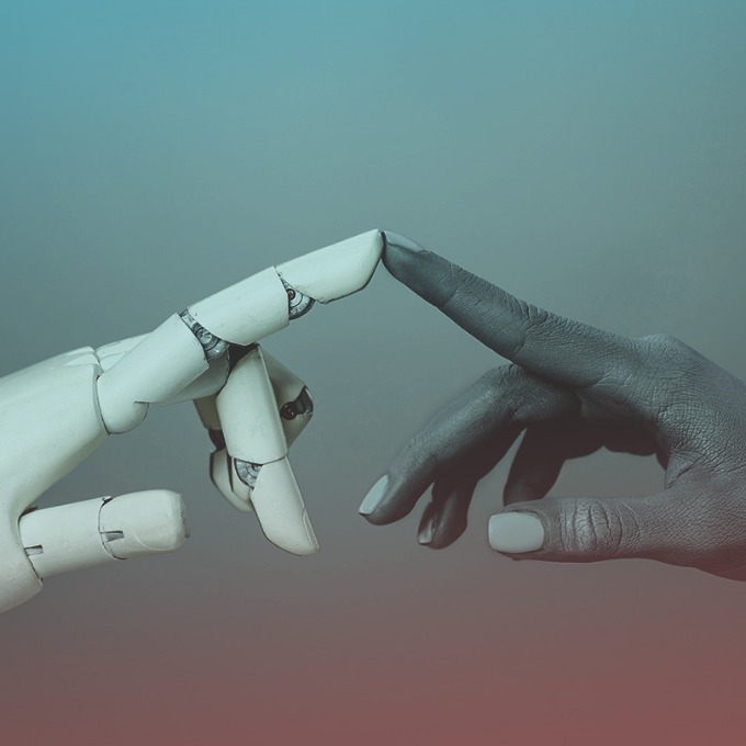 A robotic hand and human hand touching index fingers.